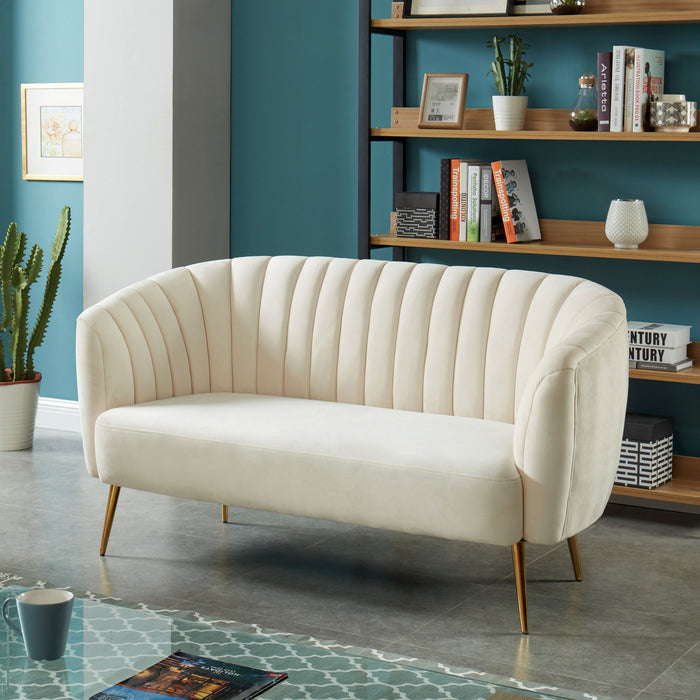 Left-angled modern glam shell tufted loveseat with ivory upholstery and gold finish legs in a contemporary living room with accessories