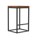 Angled view of rustic natural tone wood and black steel industrial bar stool on white background
