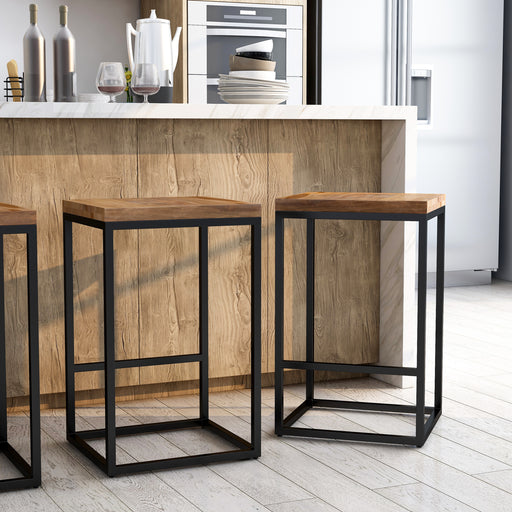 Angled view of rustic natural tone wood and black steel industrial bar stools in living space with accessories