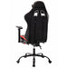 Angled back-facing view of contemporary red and black faux leather and metal gaming chair on a white background