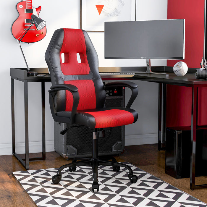Right angled contemporary black and red adjustable gaming chair with arms at a desk with accessories
