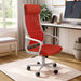Angled view of modern red fabric and white metal adjustable office chair in workspace with furnishings and accessories
