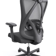 Right angled mid-chair close up view of a contemporary black office chair with mesh on a white background