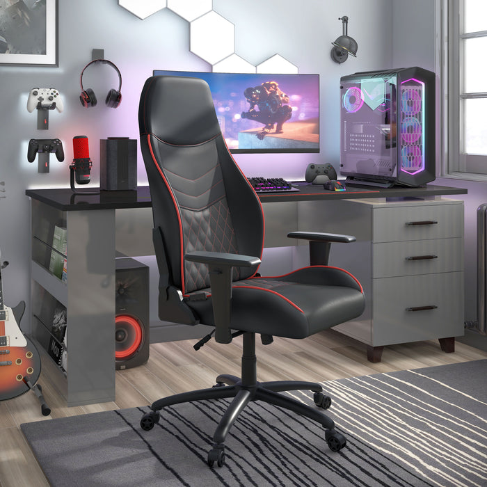 Right angled race car-inspired black and red faux leather gaming chair at a desk with accessories