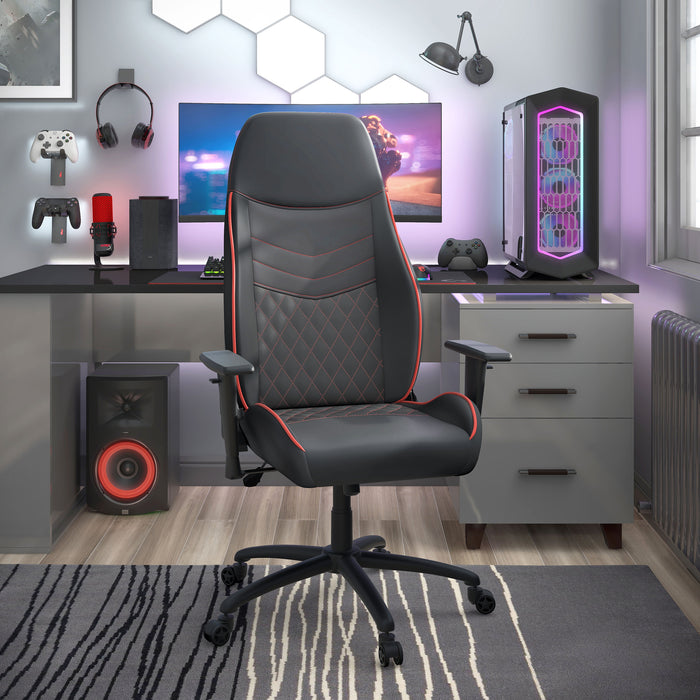 Right angled race car-inspired black and red faux leather gaming chair at a desk with accessories