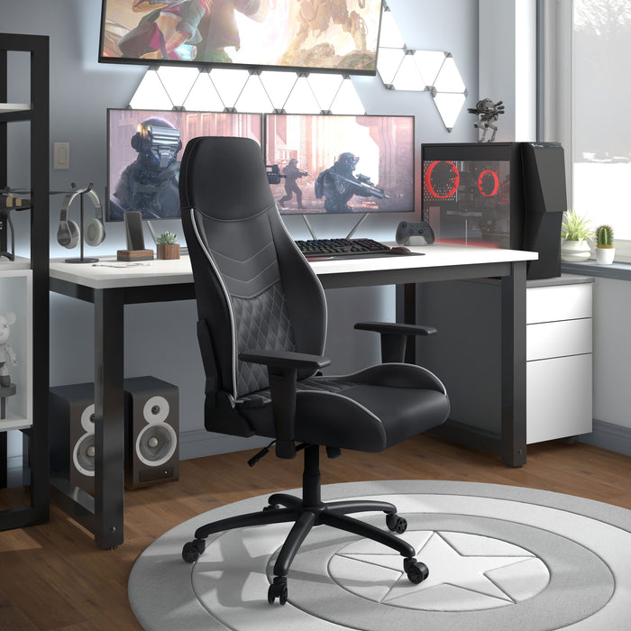 Angled side-facing view of modern black and white faux leather and strong iron adjustable gaming chair in work space with furnishings and accessories