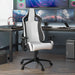 Right angled modern black and white faux leather gaming chair at a desk with accessories