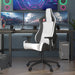 Left angled modern black and white faux leather gaming chair at a desk with accessories