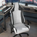 Right angled top view modern black and white faux leather gaming chair at a desk with accessories