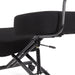 Right angled close up modern black ergonomic kneeling chair with wheels seat and adjustment detail on a white background