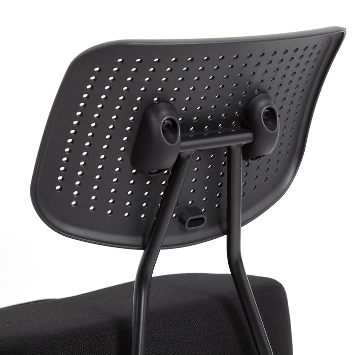 Right angled close up modern black ergonomic kneeling chair perforated seat back detail on a white background