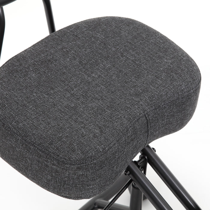 Right angled close up modern gray ergonomic kneeling chair seat cushion detail on a white background