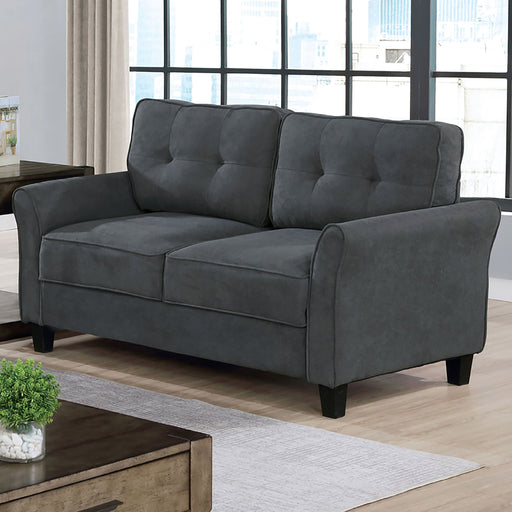 Left angled transitionald gray tufted loveseat in a living room setting. Rolled arms, welt details and tapered feet offer extra attention to detail.