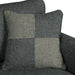 Front-facing close up dark gray loveseat with checkered pillows on a white background