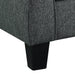 Right angled close up dark gray loveseat with checkered pillows on a white background