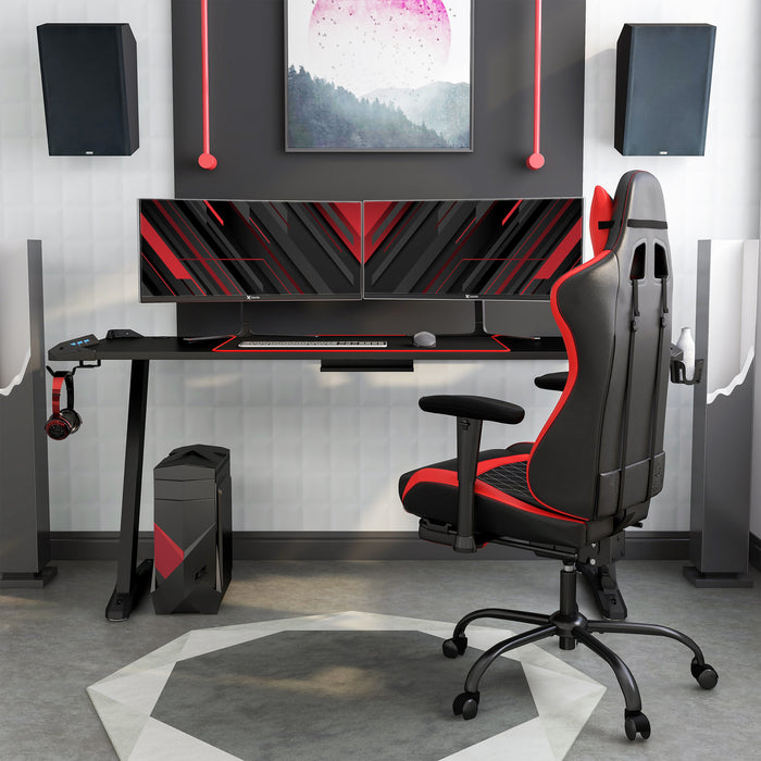 Front facing contemporary black gaming desk with red accents in a living space with accessories