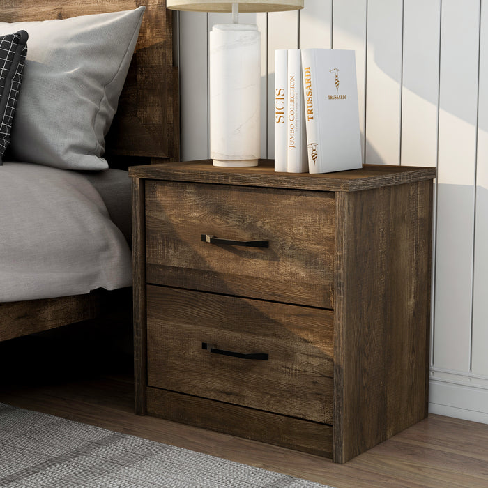 Left-angled rustic walnut 2-drawer nightstand in a farmhouse-style bedroom. The bedside table holds a white marble vase lamp and books. The country-style bed is adorned with neutral grey bedding while the shiplap wall is a clean white.