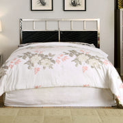 Front-facing modern glam black and chrome bed with wave headboard details and linens in a contemporary bedroom