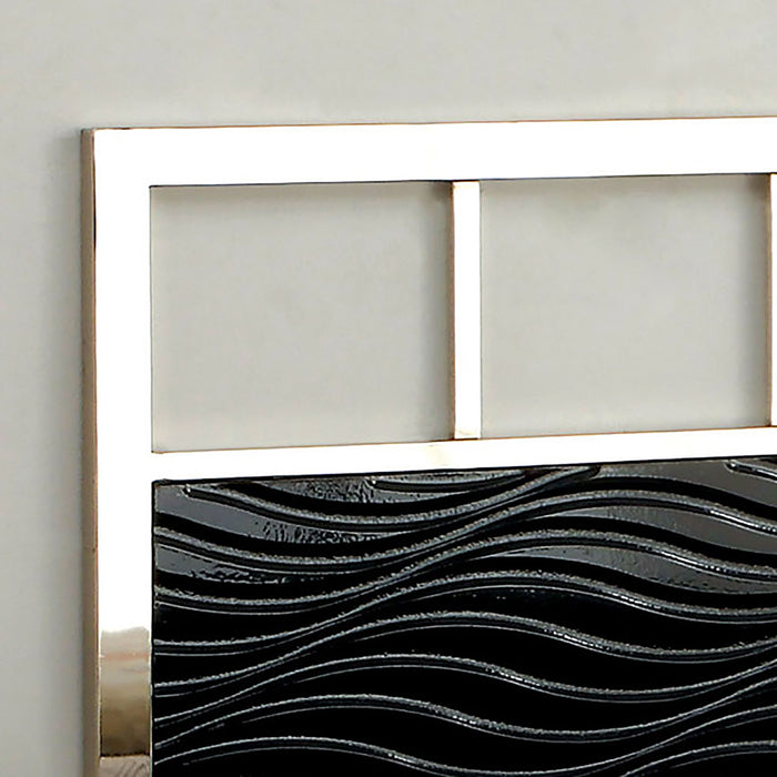 Right-angled close up modern glam black and chrome bed headboard detail against an off-white bedroom wall