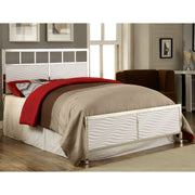 Right-angled modern glam white and chrome bed with wave headboard details and linens in a contemporary bedroom