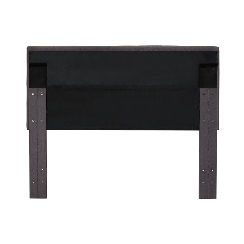 Back-facing grey fabric upholstered headboard on a white background.Back-facing grey fabric upholstered headboard on a white background.