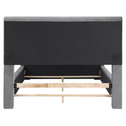 Front-facing back view of a modern glam gray upholstered bed on a white background