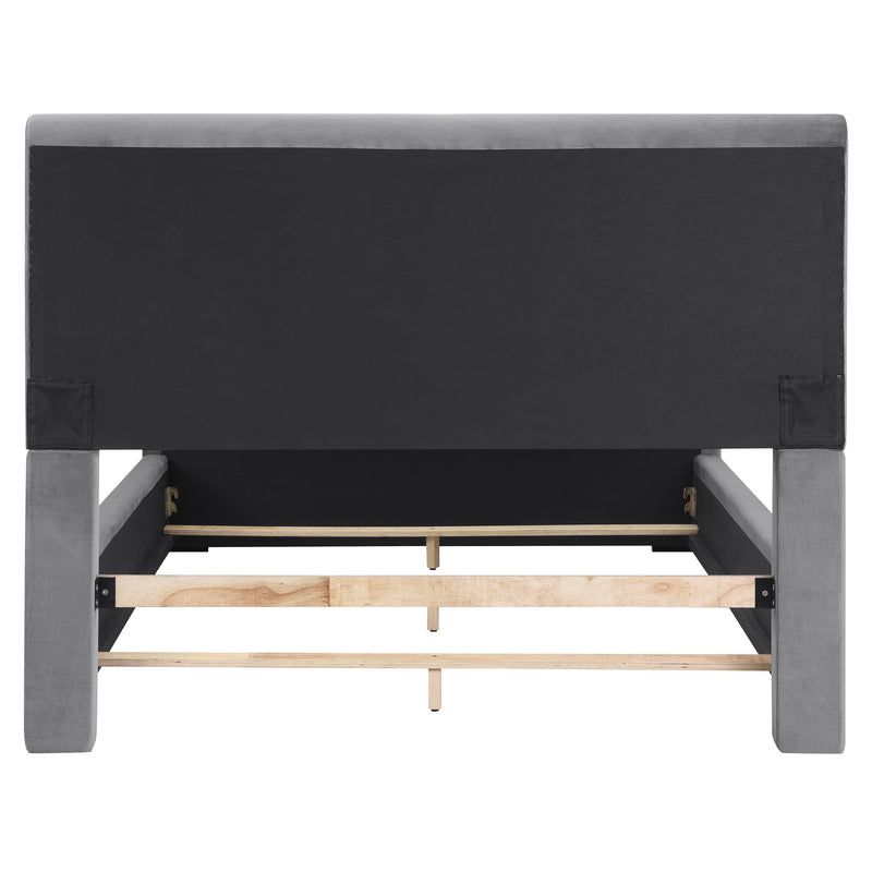 Front-facing back view of a modern glam gray upholstered bed on a white background