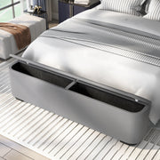 Left-angled close-up of the storage footboard on a modern glam gyay upholstered bed in a stylish bedroom.