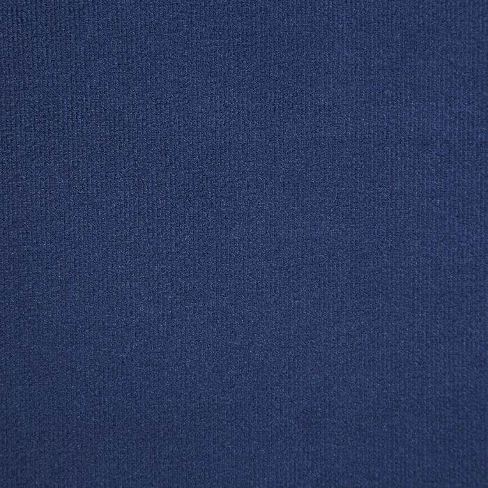 Swatch of navy blue upholstery on a modern glam upholstered bed