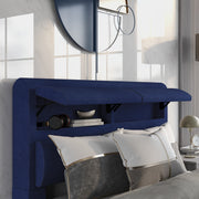 Right-angled close-up of the hidden storage headboard on a modern glam navy blue upholstered bed in a stylish bedroom with accessories