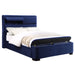 Right-angled modern glam navy blue upholstered bed with head and footboard storage on a white background