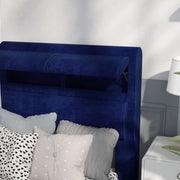 Left-angled close-up of the hidden storage headboard on a modern glam navy blue upholstered bed in a stylish bedroom