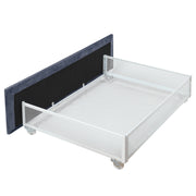 Left-angled side view close-up on the underbed drawer of a modern glam gray upholstered bed on a white background