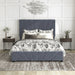 Front-facing modern glam gray upholstered storage bed with radiant channel tufting and underbed drawers in a stylish bedroom with linens and accessories