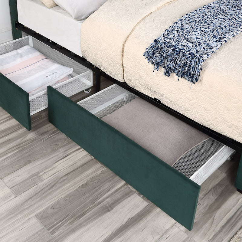 Left-angled close-up view of underbed drawers of a modern glam dark green upholstered storage bed with nailhead trim in a stylish bedroom with linens and accessories