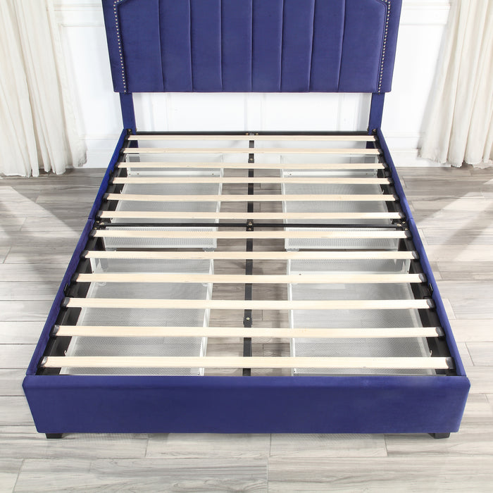 Front-facing top-down view of a modern glam navy blue upholstered storage bed with nailhead trim and underbed storage drawers with no mattress in an empty bedroom