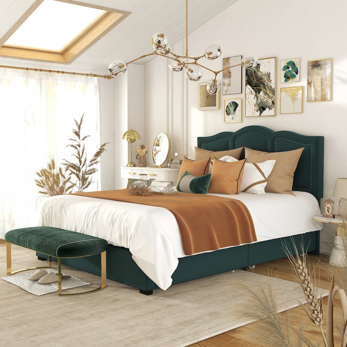 Left-angled modern glam dark green upholstered storage bed with panel-style nailhead trim and underbed drawers in a stylish bedroom with linens and accessories