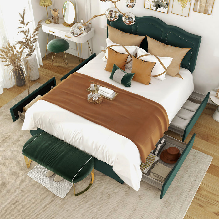 Left-angled top-down view of a modern glam dark green upholstered storage bed with panel-style nailhead trim and underbed drawers extended in a stylish bedroom with linens and accessories