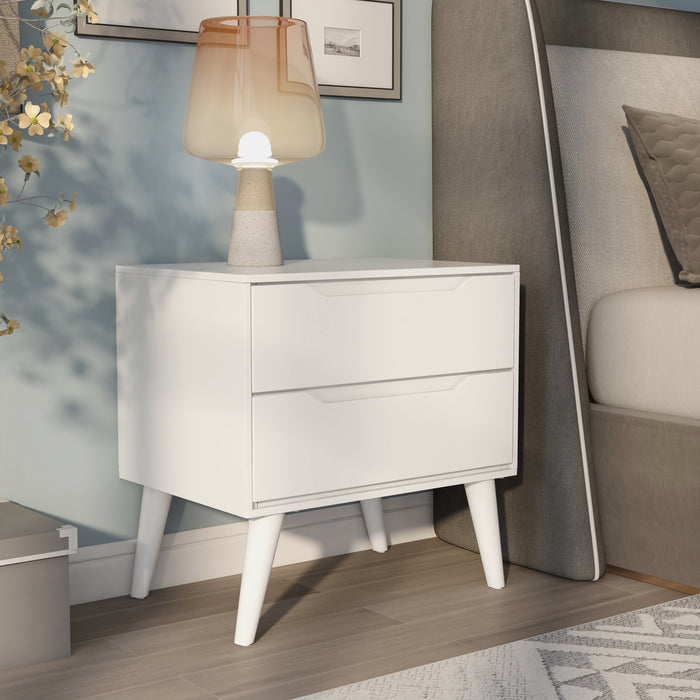 Right-angled white mid-century modern style nightstand in a contemporary bedroom.