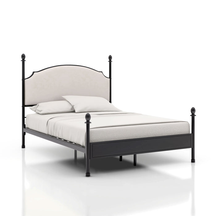 Right-angled California King-sized four-poster bed sits against a white background. The camelback is a beige upholstery while the frame of the bed is a gunmetal finish with slender posts that present ball finials.