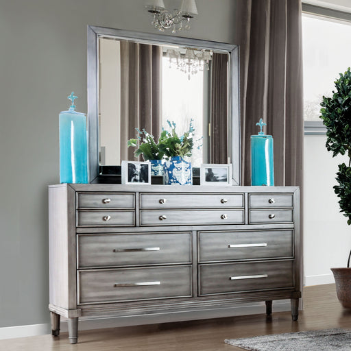 Right-angled framed weathered gray mirror on a dresser in a contemporary bedroom with accessories