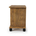 Left-facing oak nightstand against a white background. The traditional style design stands on black cylindrical feet.