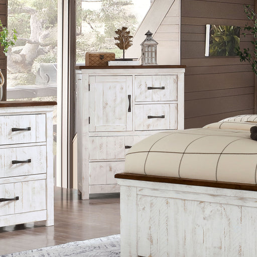 Right-angled white wood grain accent cabinet with one door and four drawers and a contrasting dark wood top in a modern farmhouse bedroom
