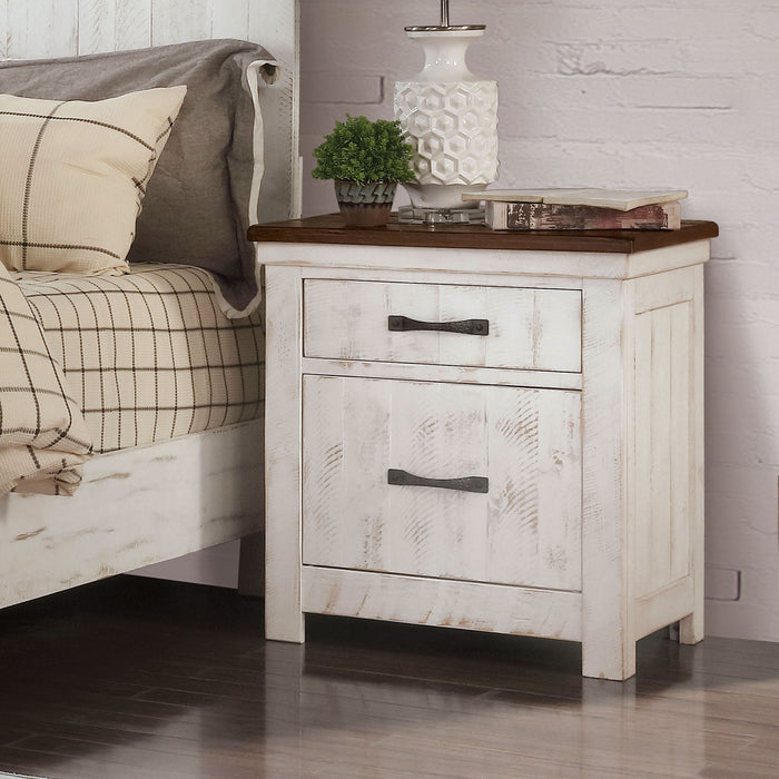 Left-angled white wood grain nightstand with two drawers and a contrasting dark wood top in a modern farmhouse bedroom