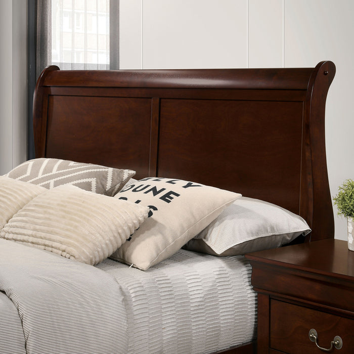 Left-angled close-up of the headboard on a transitional cherry finish wooden sleigh bed in a stylish bedroom with linens and accessories