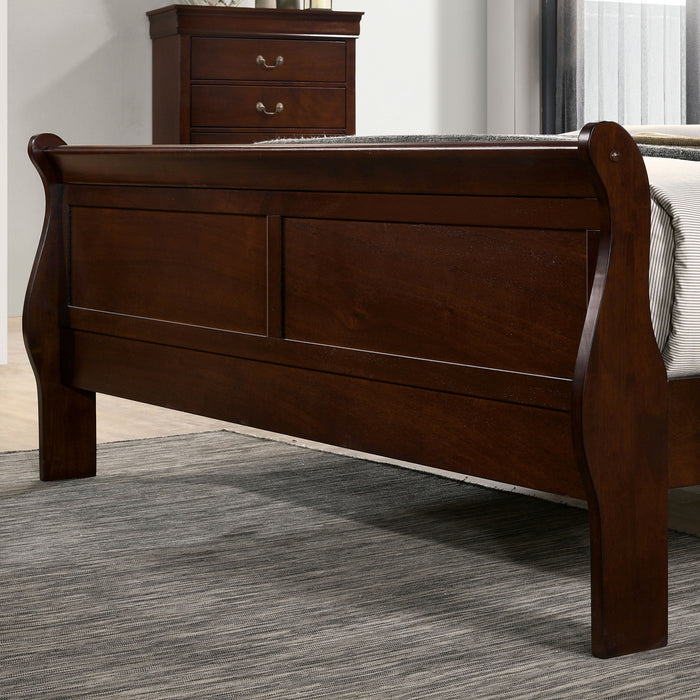 Left-angled close-up of the footboard on a transitional cherry finish wooden sleigh bed in a stylish bedroom with linens and accessories