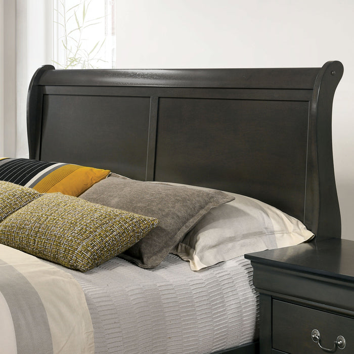 Left-angled close-up of the headboard on a transitional gray finish wooden sleigh bed in a stylish bedroom with linens and accessories