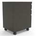 Right angled back view of a contemporary three-drawer gunmetal locking file cabinet with wheels on a white background