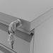 Left angled close up lock and key detail of a contemporary three-drawer silver locking file cabinet with wheels