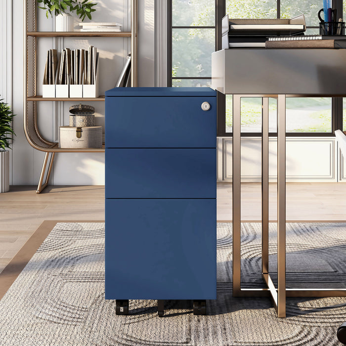 Front-facing modern navy blue steel file cabinet rolled up to home office desk. Convenient security lock and black wheels.